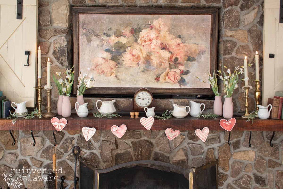 Vintage Valentine's Day decor idea featuring a mantel in rustic style with hearts garland