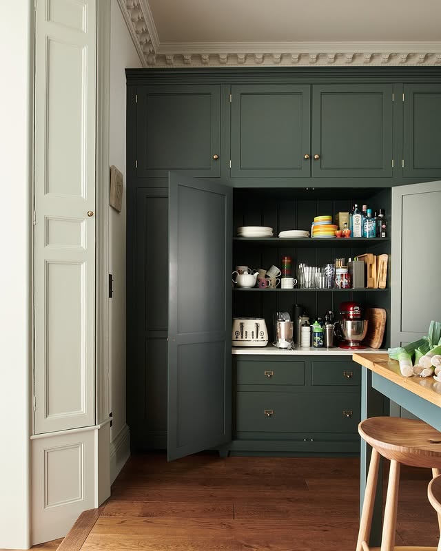 Example of modern kitchen decor trends featuring a kitchen in contemporary style in blue tones hidden pantry
