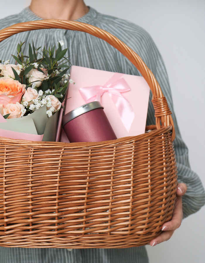 image of woman holding a basket with many gifts, example of Valentine's day gift ideas for her