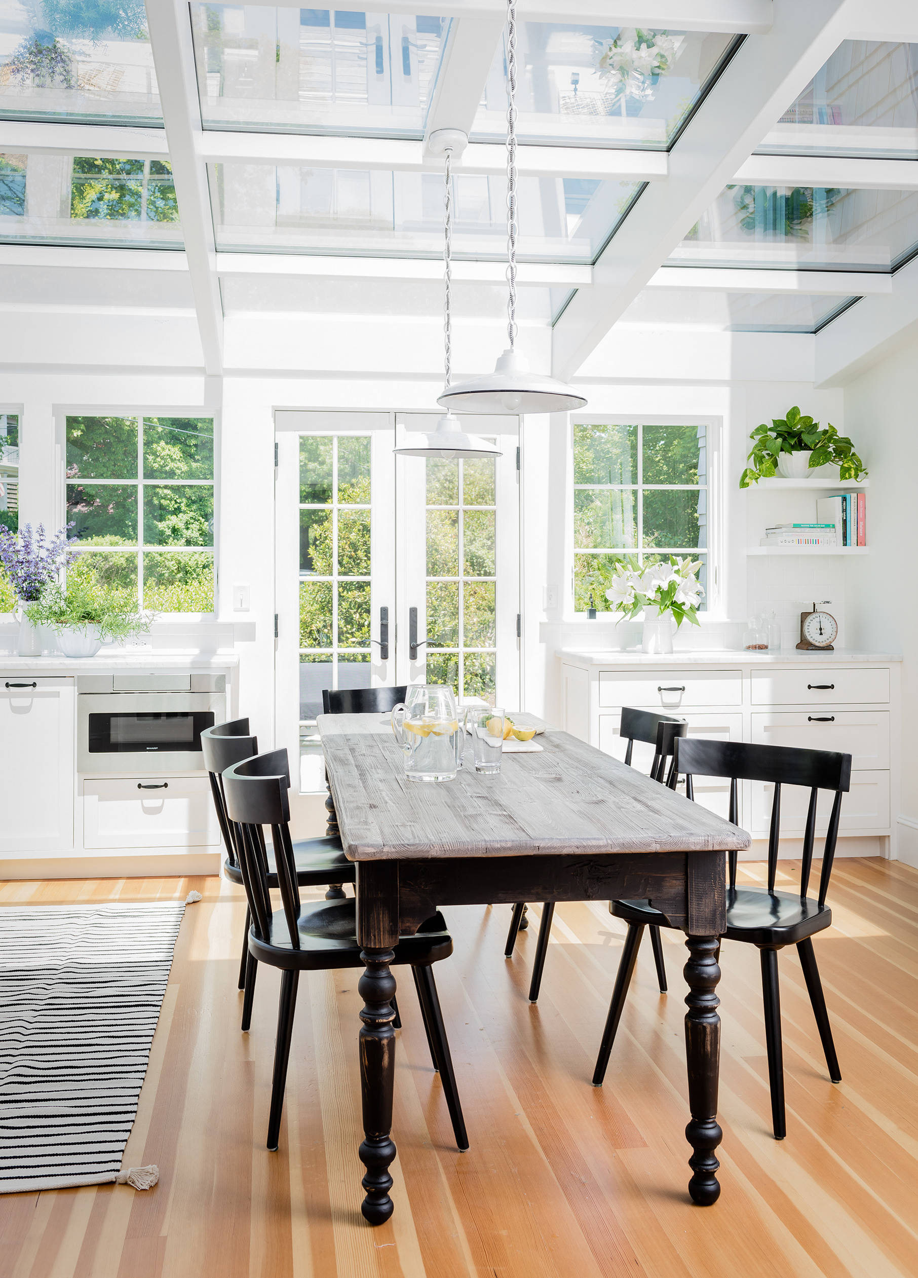 Example of French kitchen style decor featuring a large kitchen with open windows in white and black