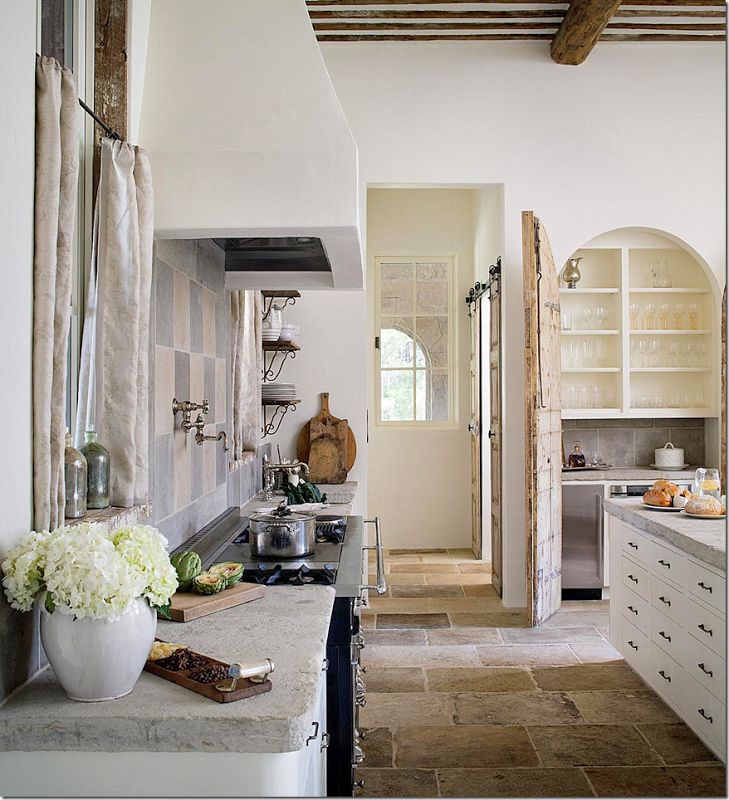 Example of French kitchen style decor featuring a kitchen with contemporary and traditional furniture