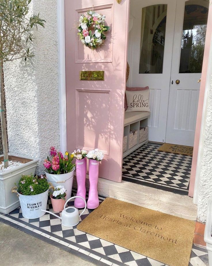 Spring front porch ideas featuring a fun design with a pink door and rain boots
