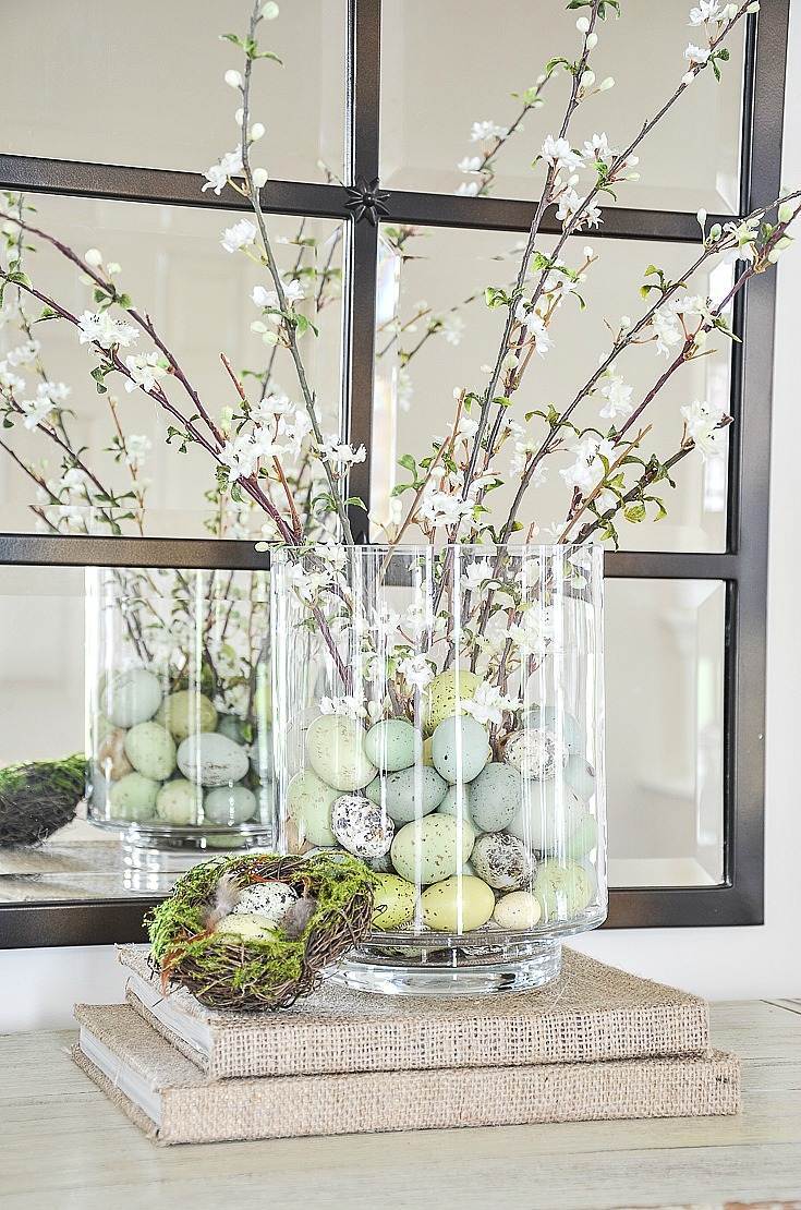 Eastern entryway table decor idea featuring clear vase with egg tree branches