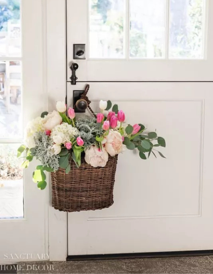 spring wreath for your front door idea featuring basket wreath with silvery greenery and pink florals