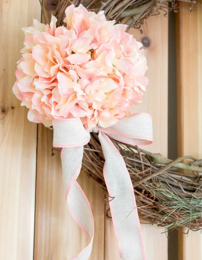 spring wreath for your front door idea featuring a neutral option with branches and pink flowers