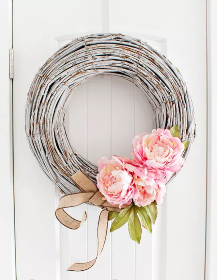spring wreath for your front door idea featuring a neutral option with branches and pink flowers