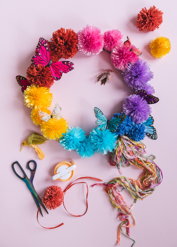 spring wreath for your front door idea featuring colorful paper flowers and butterflies