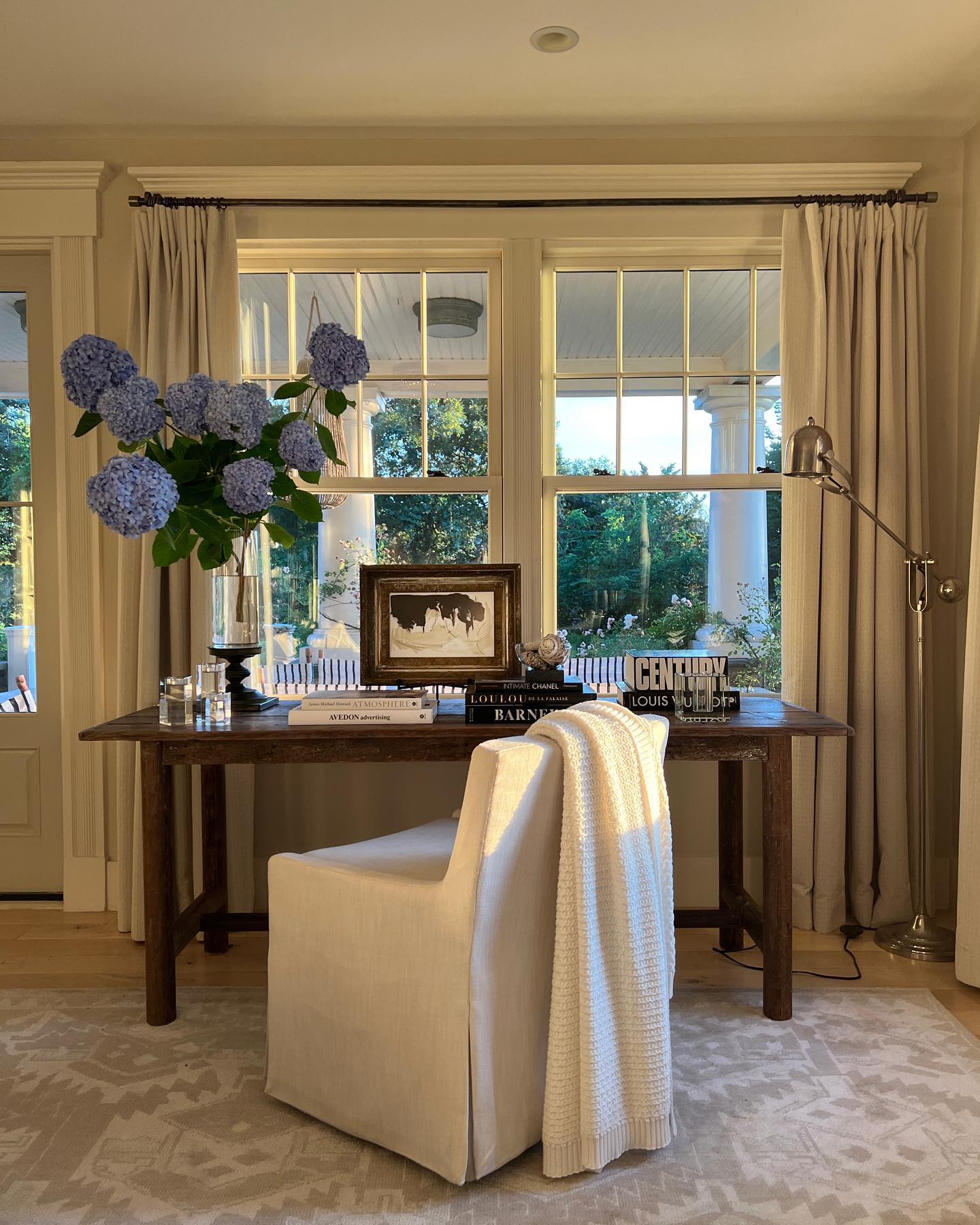 Nancy Meyers interiors inspiration example showcasing a traditional home desk with comforting layered decor