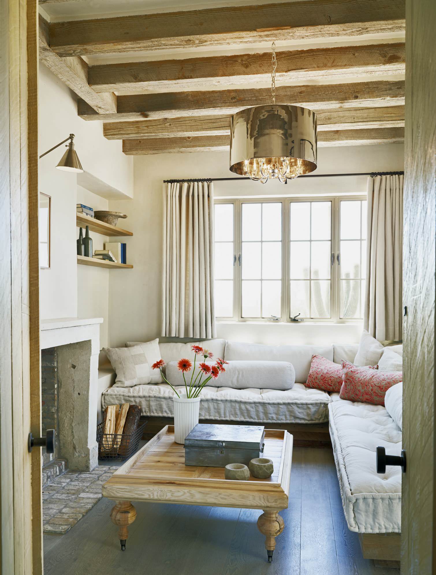 Statement pieces used as unique artworks in a eclectic and rustic living room featuring a metallic chandelier