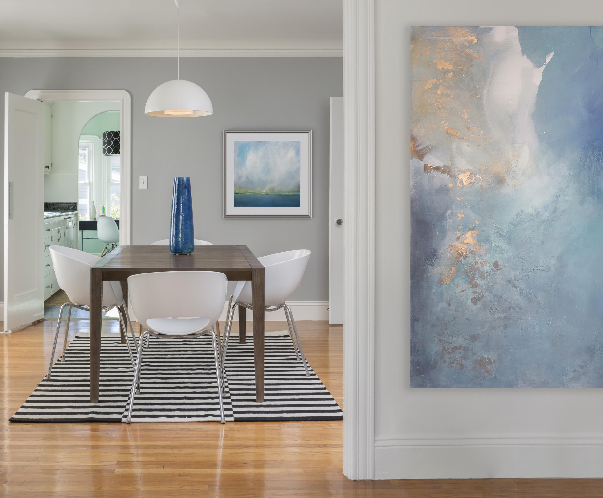 Statement pieces used as unique artworks in a traditional preppy living room featuring a coastal painting.