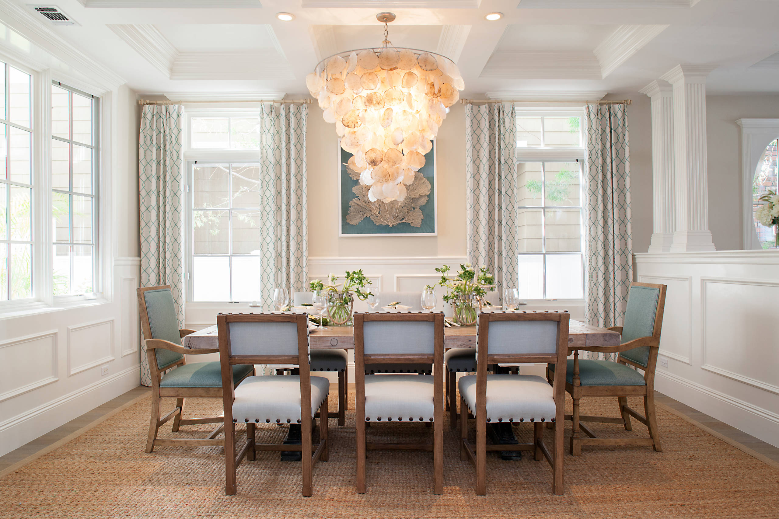 Statement pieces used as unique artworks in this traditional dining room featuring a structural coastal lamp.
