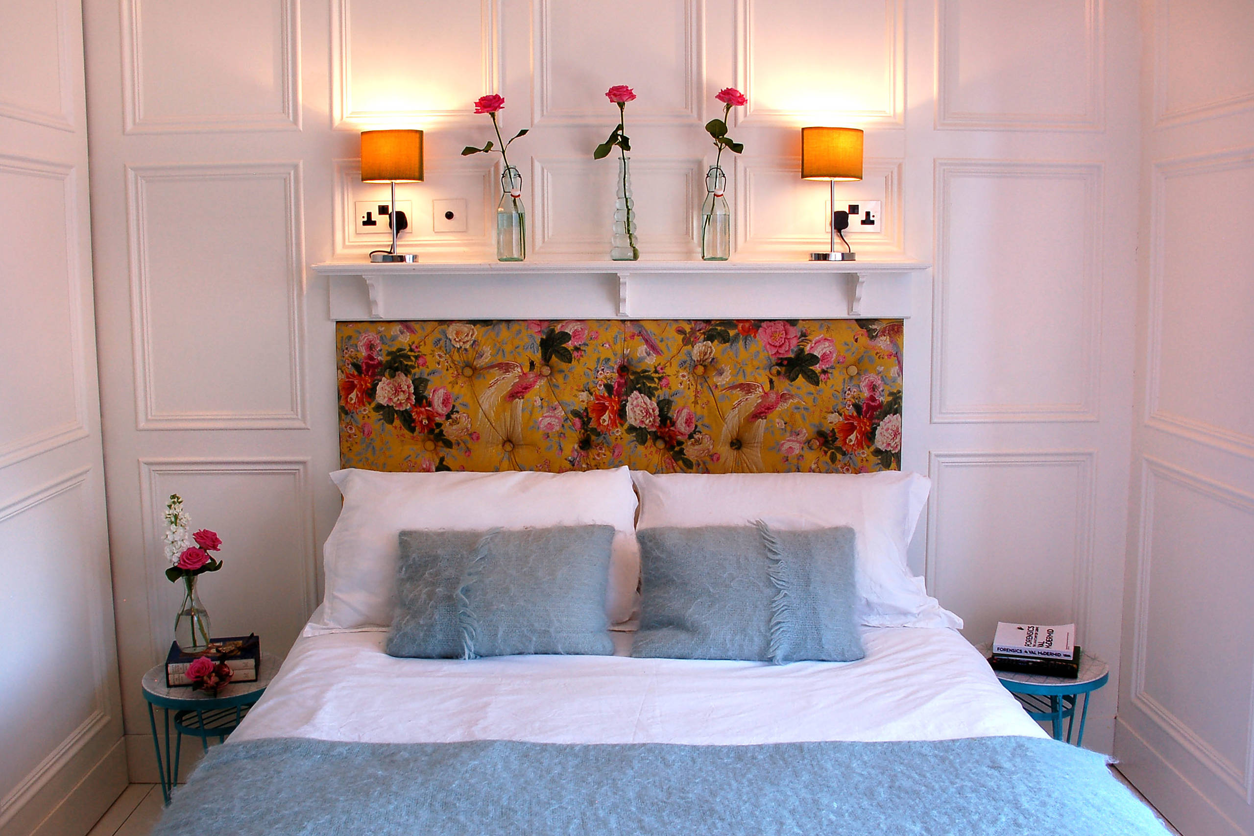 Statement pieces used as unique artworks in this bedroom featuring a focal headboard.