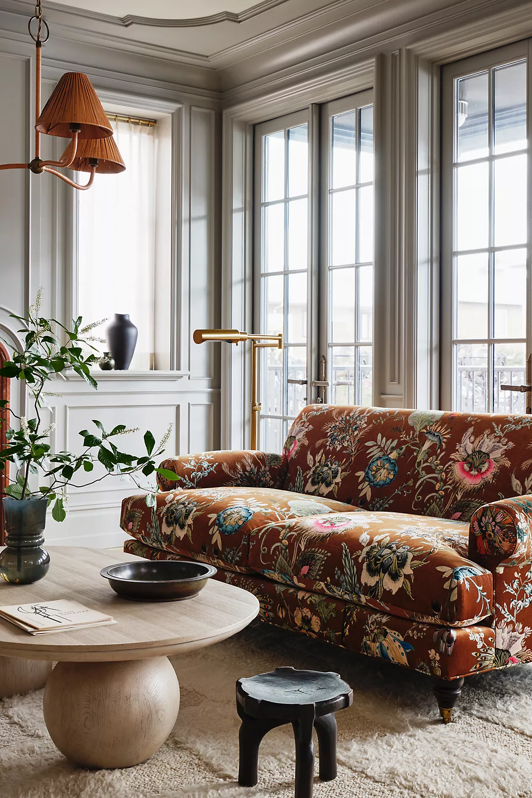 Statement pieces used as unique artworks in a eclectic traditional living room featuring a floral sofa