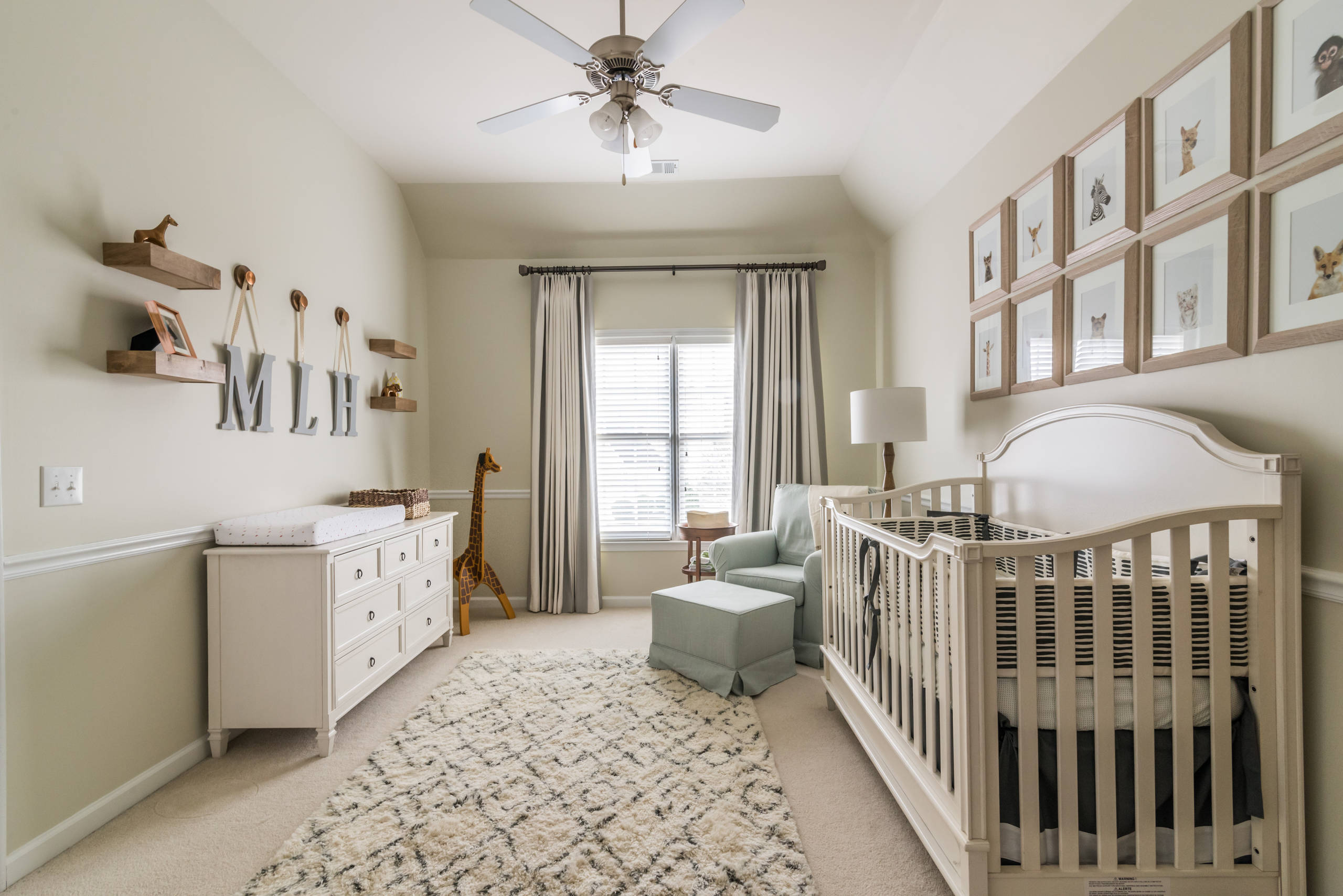 Vintage inspired nursery example featuring a traditional style in neutral blue color scheme