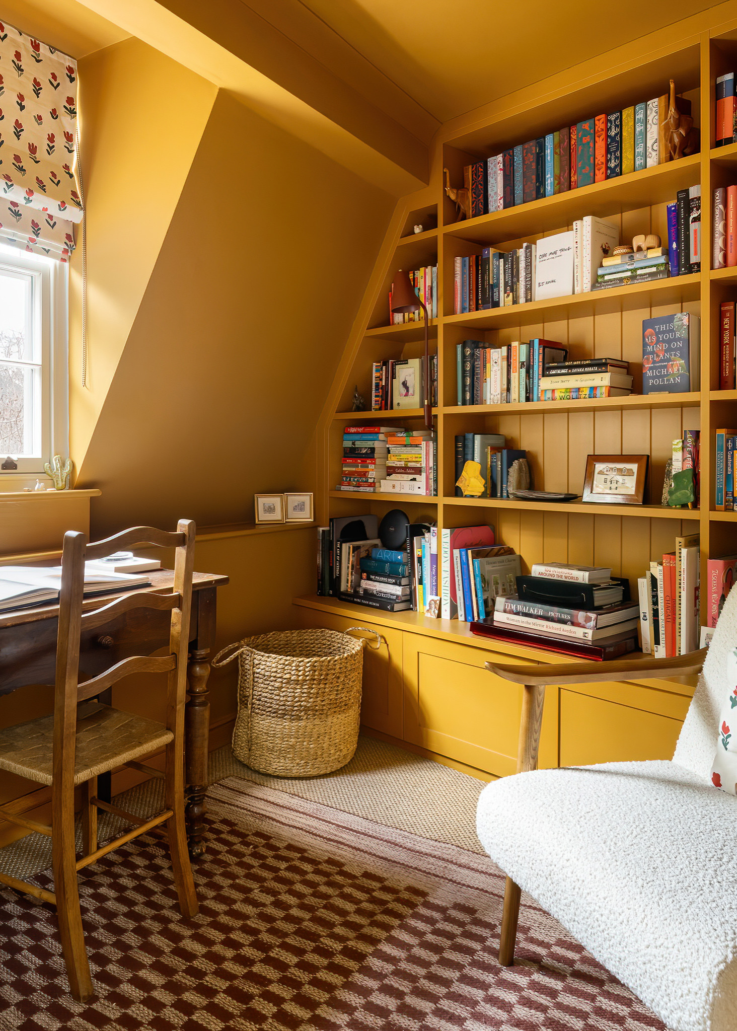 Color drenching idea showing a home study in a bright deep yellow with bookcases in the same hue, books contrasting against it