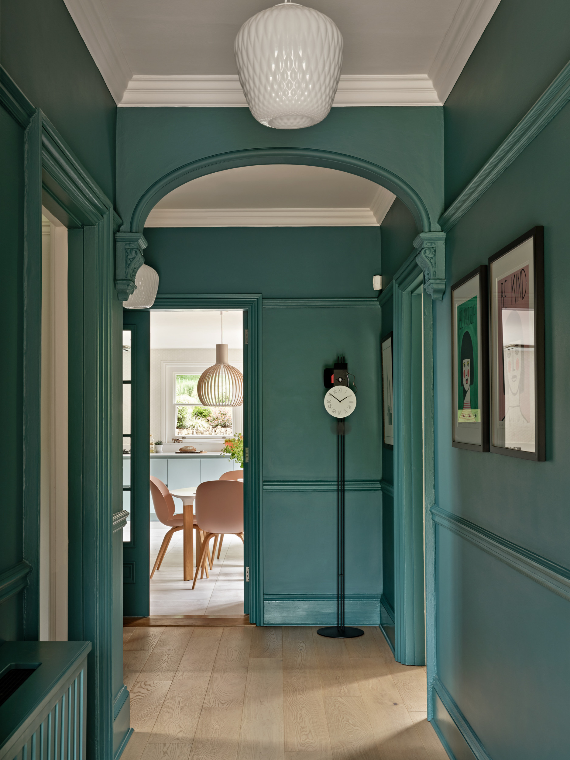 Color drenching idea showing a hallway entryway in rich soft green