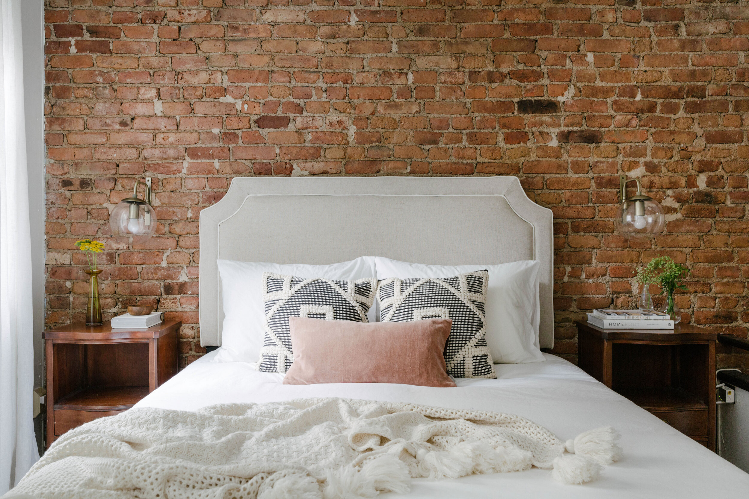 Industrial-inspired neutral bedroom in warm color palette