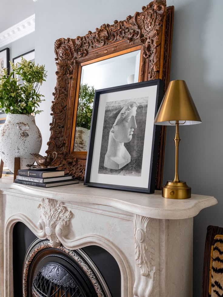 Example of transitional mantel decor style featuring a modern traditional look