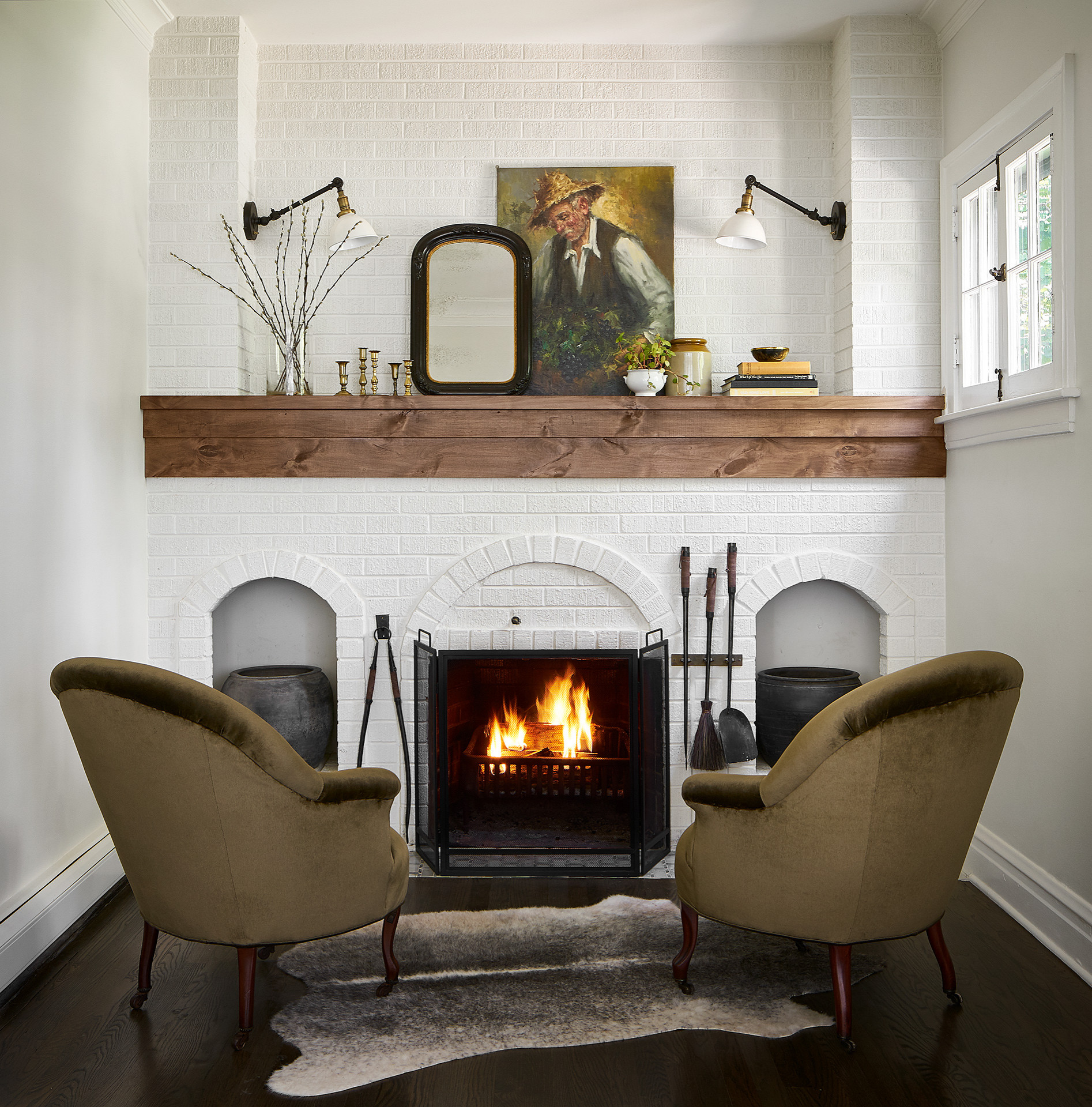 Example of transitional mantel decor style featuring a modern cottage look