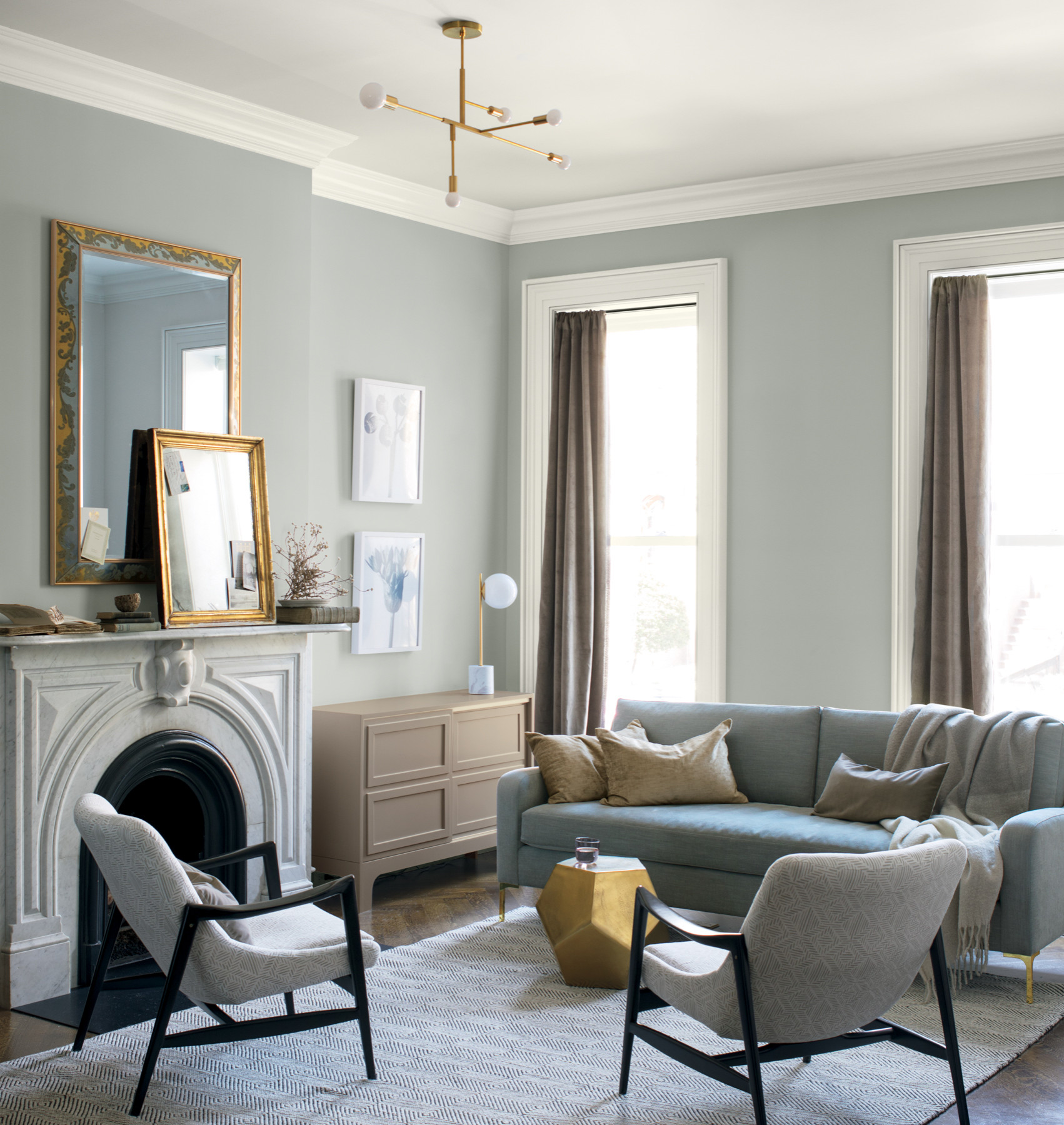 Example of transitional mantel decor style featuring a modern traditional look