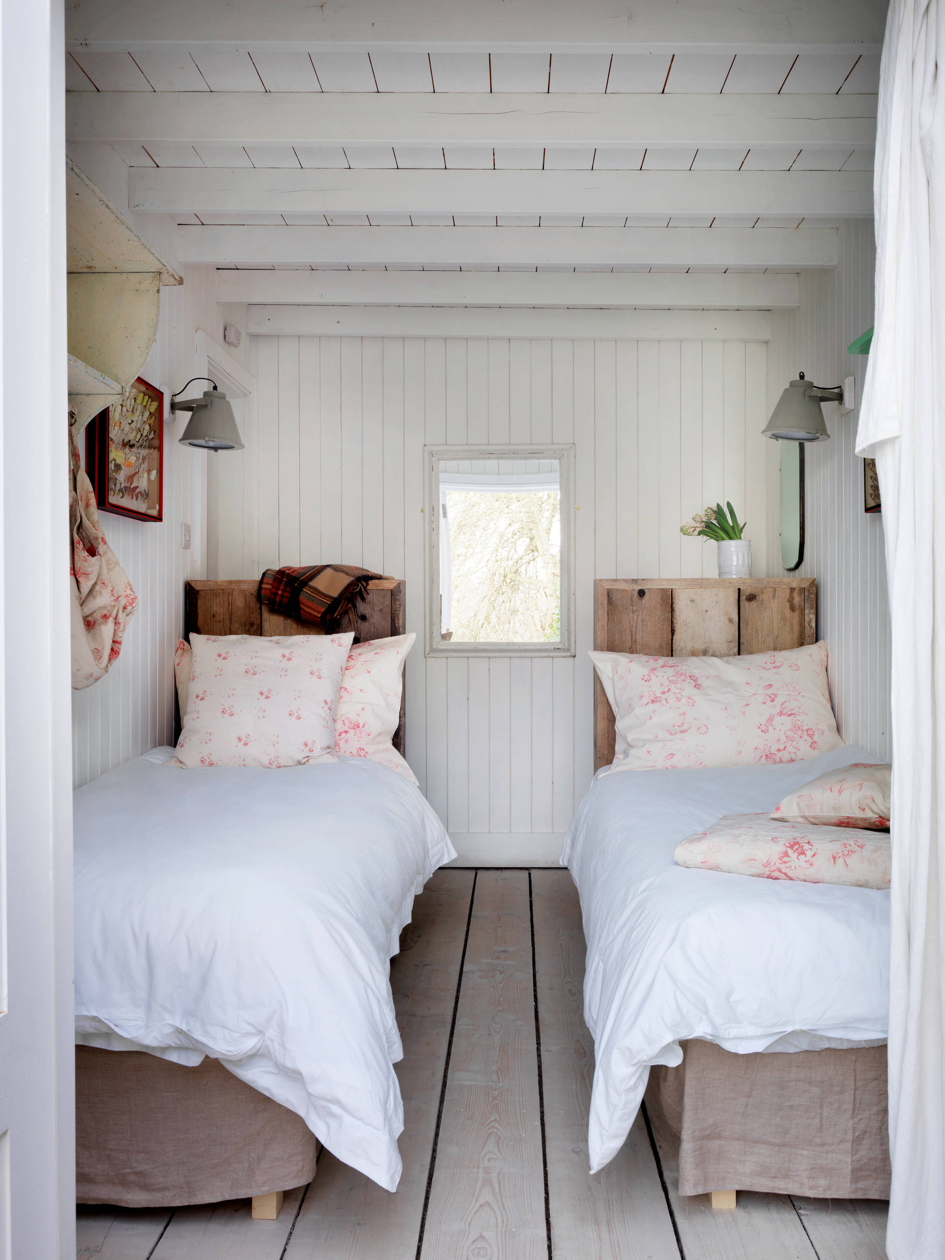 photo featuring beach cottage bedroom in white and blue color palette with twin beds