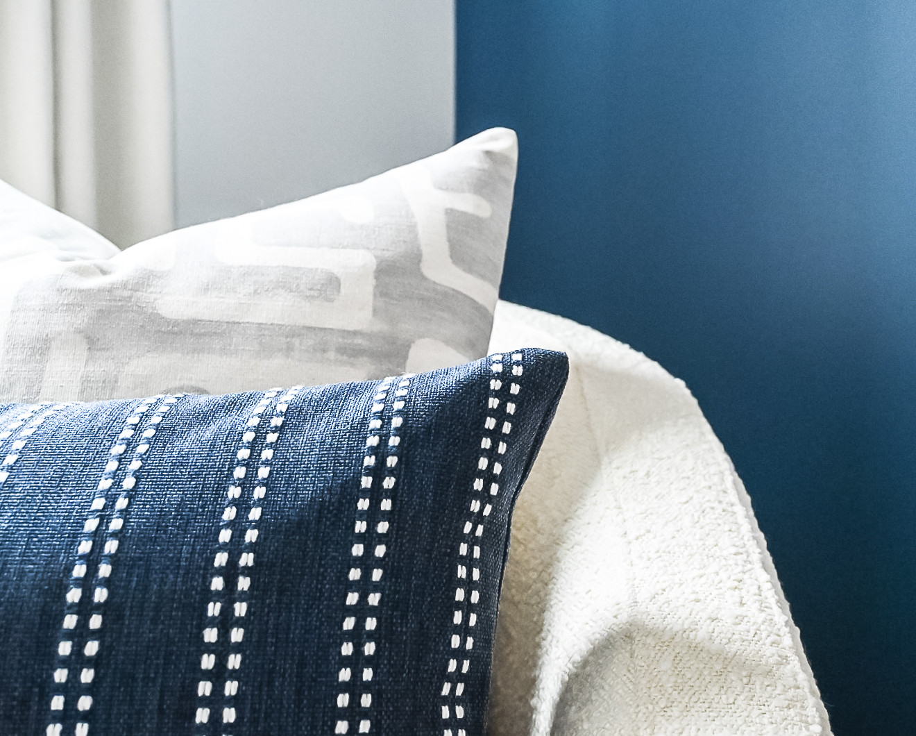 boucle fabric example featuring a close up of throw pillow group in modern coastal style
