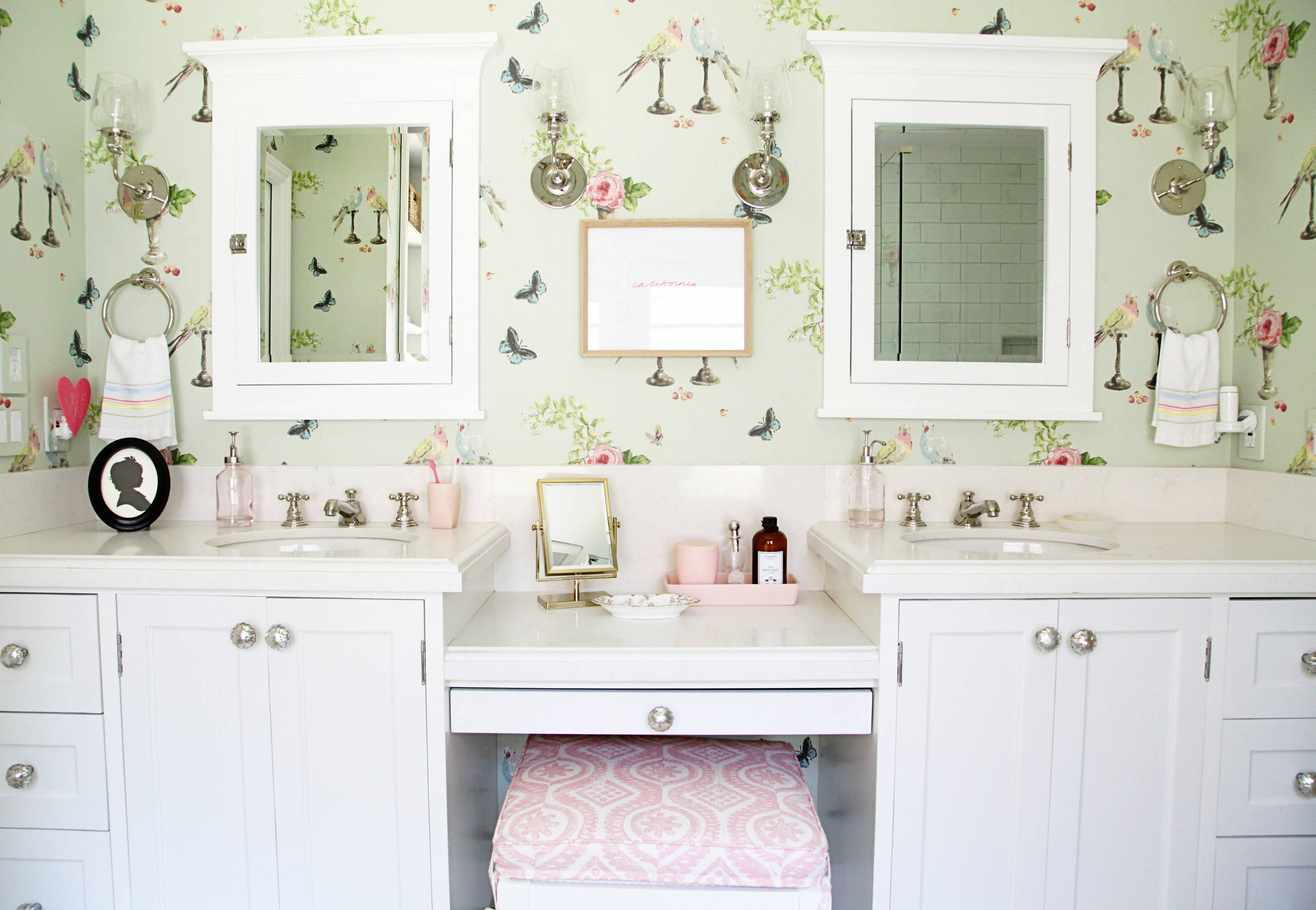 Jack and Jill bathroom example showcasing a traditional floral wallpaper in litle green and pink