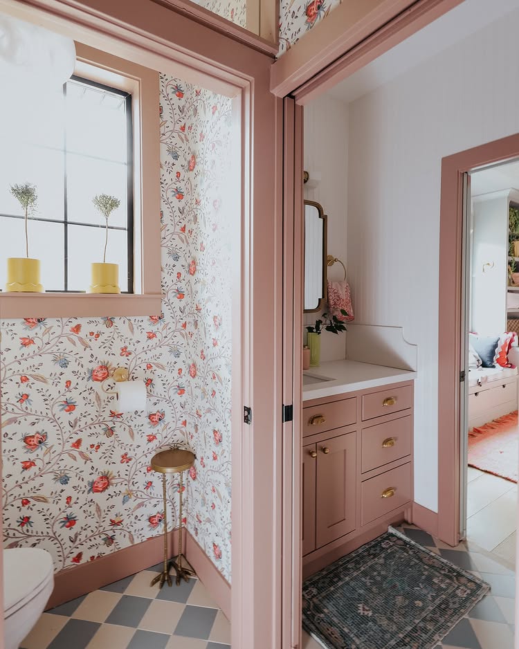 Jack and Jill bathroom example showcasing a whimsical girls bathroom in dust pink and dark yellow color scheme with floral wallpaper