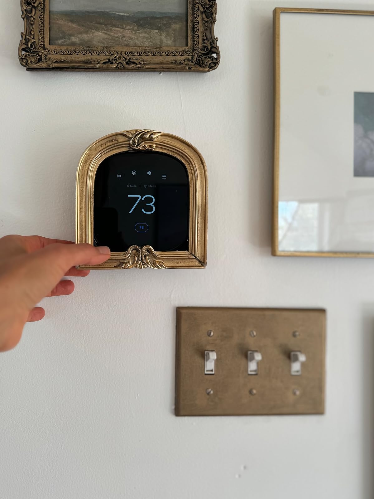 wall featuring smart home gadgets like google nest in antique frame