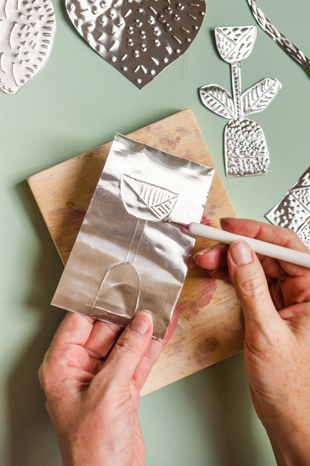 Crafternoon idea featuring hands making tin embossing project