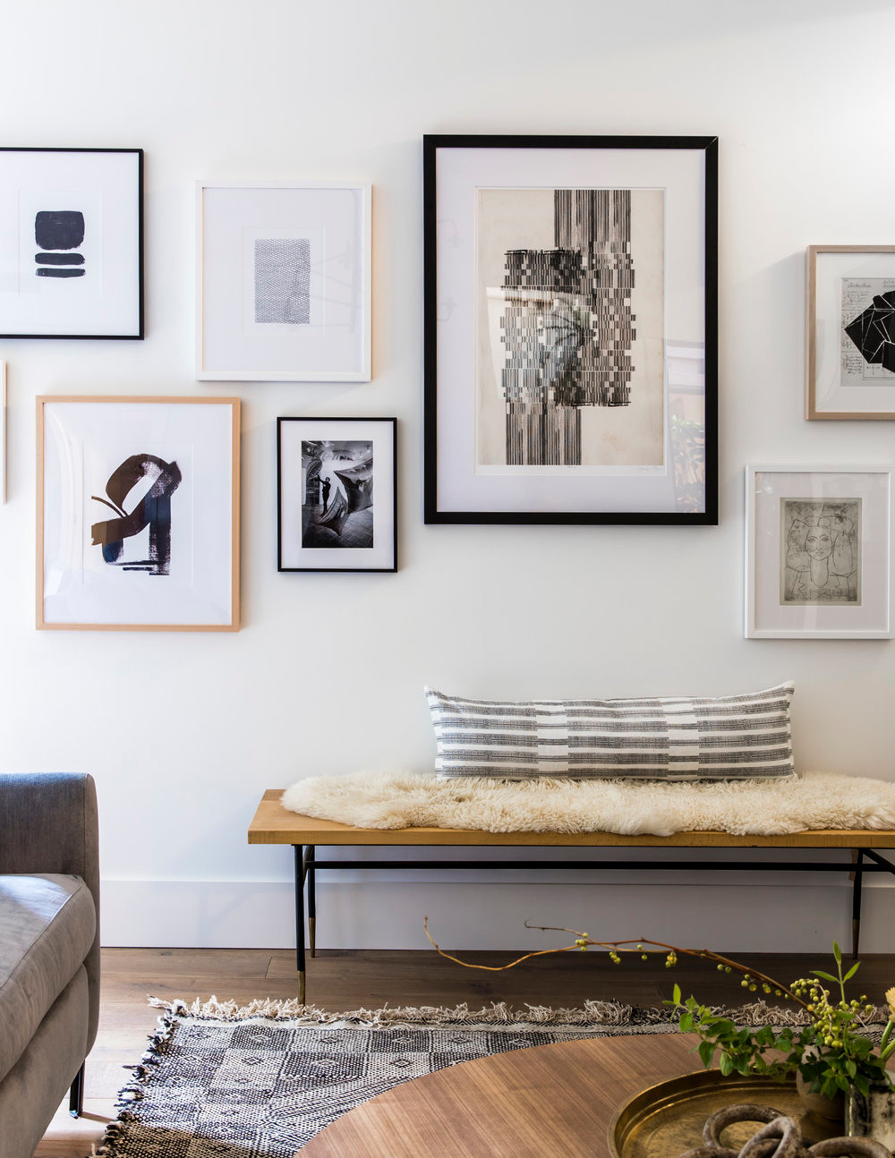 Contemporary home tour featuring bench below gallery wall