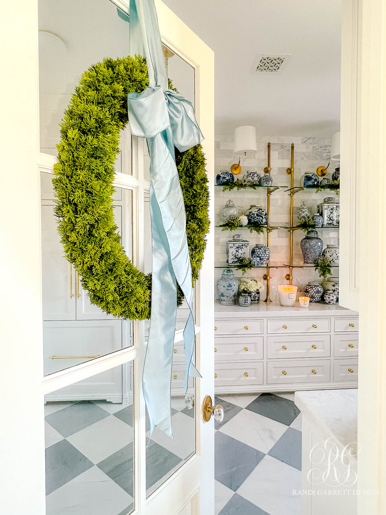 French door with wreath and blue ribbon shown as example of pastel Christmas decor ideas