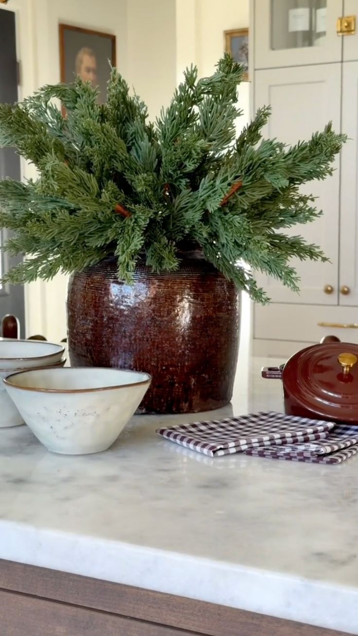 Budget Christmas kitchen styling tips and ideas featuring island with ceramic vase with greenery