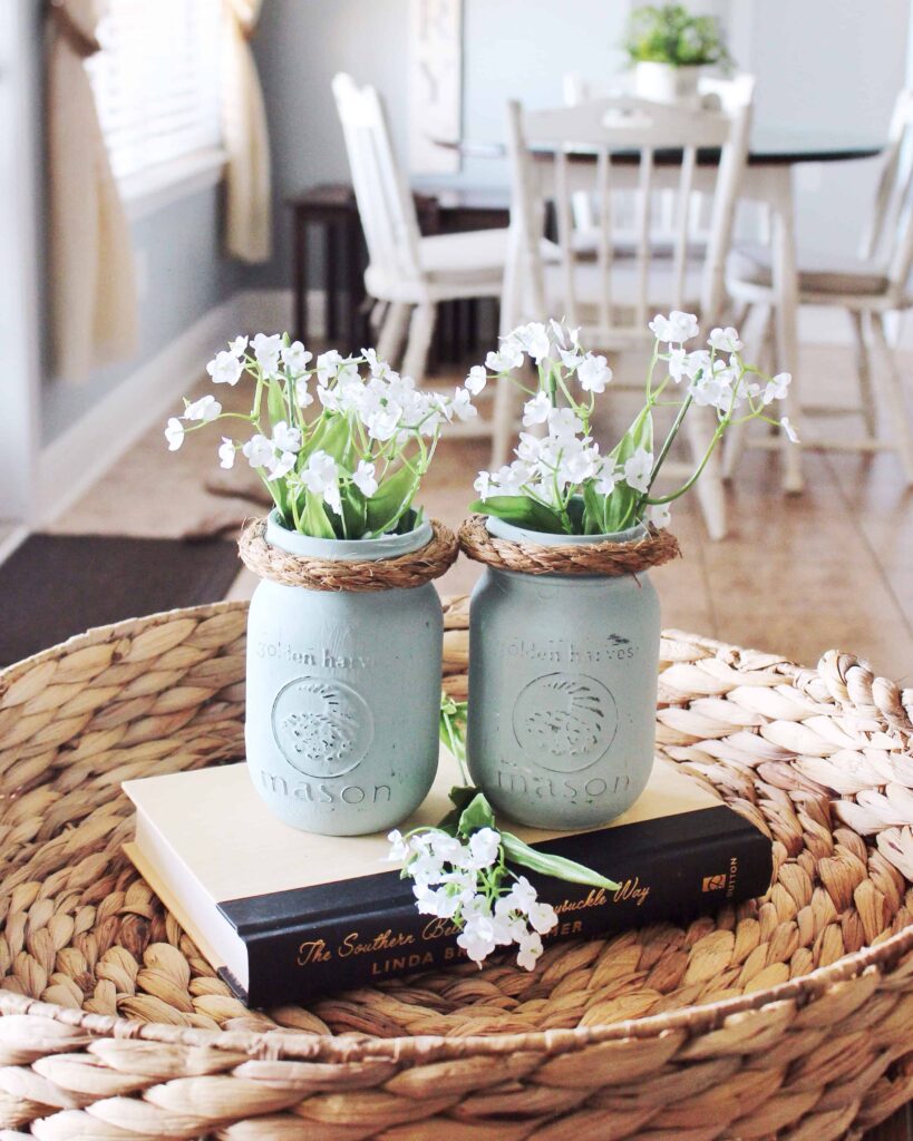 Light blue painted mason jars with white flowers as neutral easter decor idea