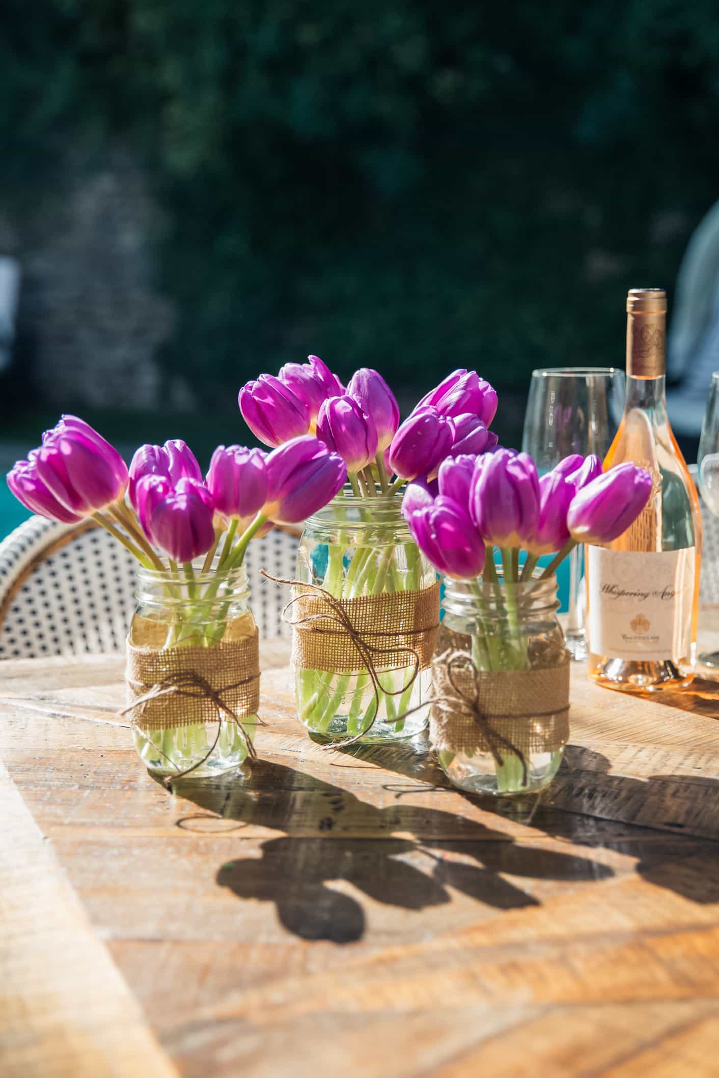 centerpiece with Clear Mason Jars and Bright florals as neutral Easter decor idea