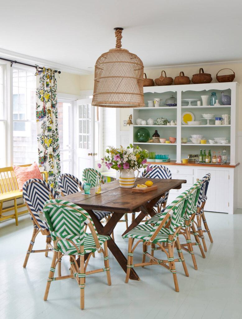 Whimsical coastal cottage interior featuring a home casual dining room in home tour