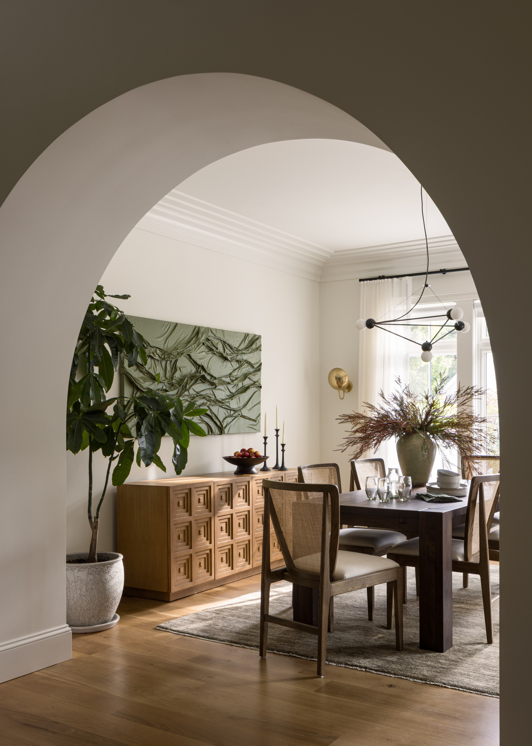 Dining room featured in Lee Boulevard Home Tour as an example of a Historic Home Renovation with a transitional modern heritage style.