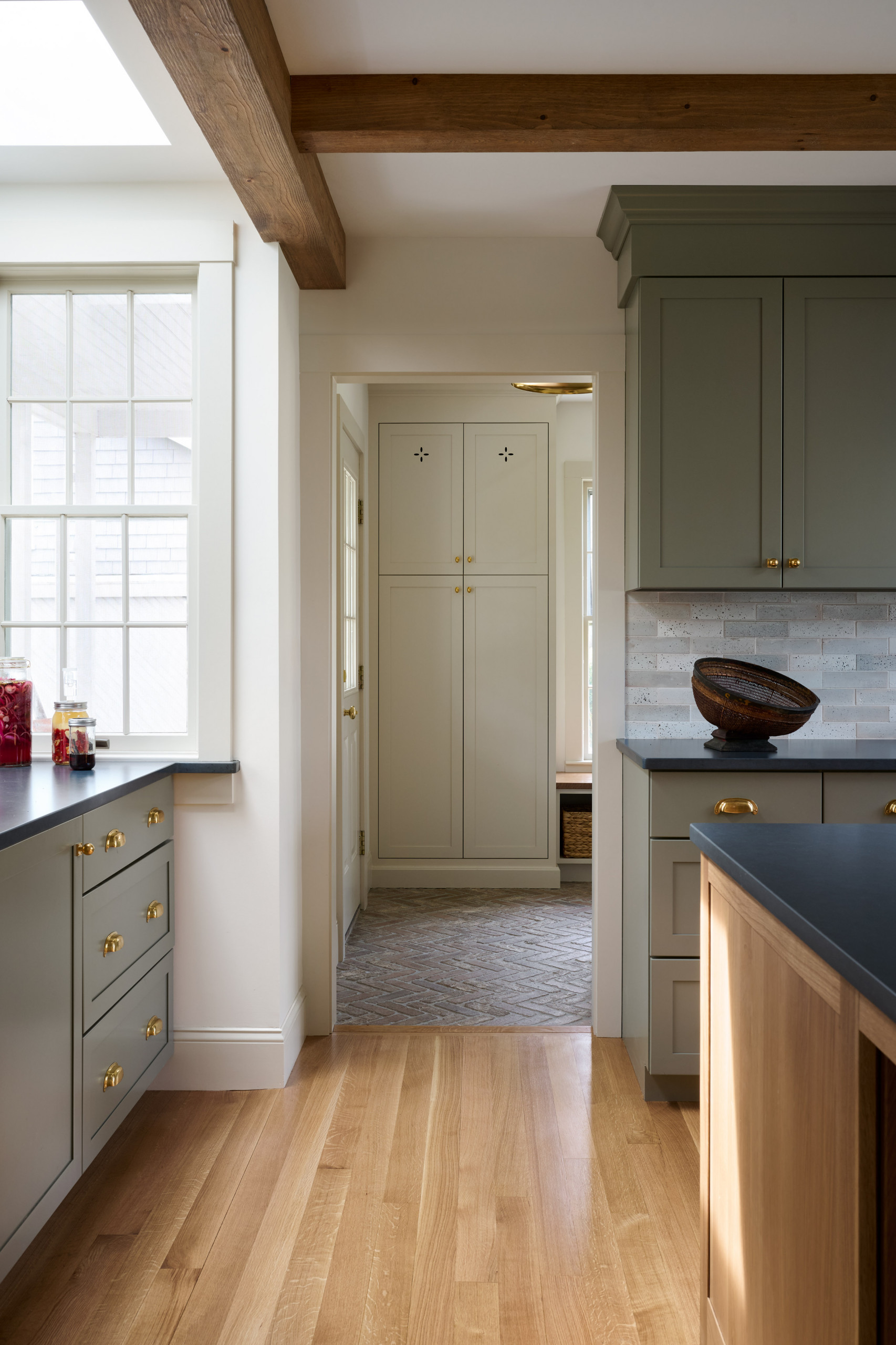 Kitchen from Seaside Colonial home tour designed by Beige and Bleu Design Studio in modern transitional heritage style.