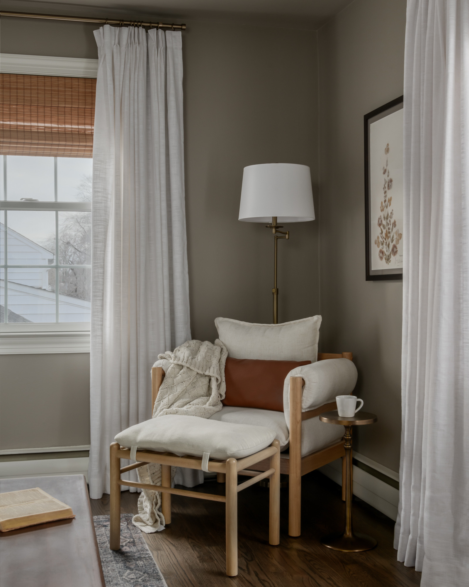 Guest bedroom with modern oak chair in a colonial home tour