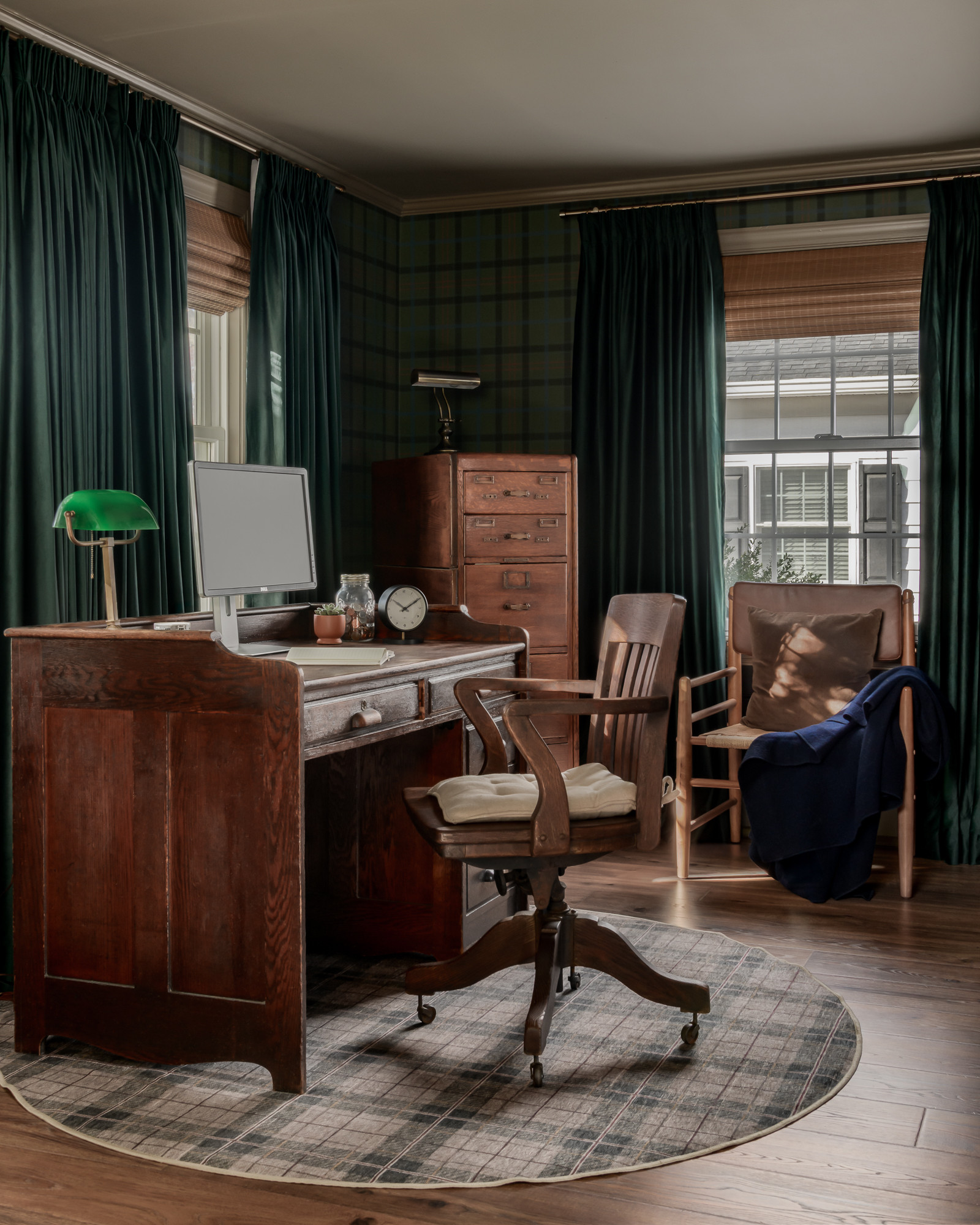 Office desk with green plaid wallpaper and emerald velvet drapery in a colonial home tour