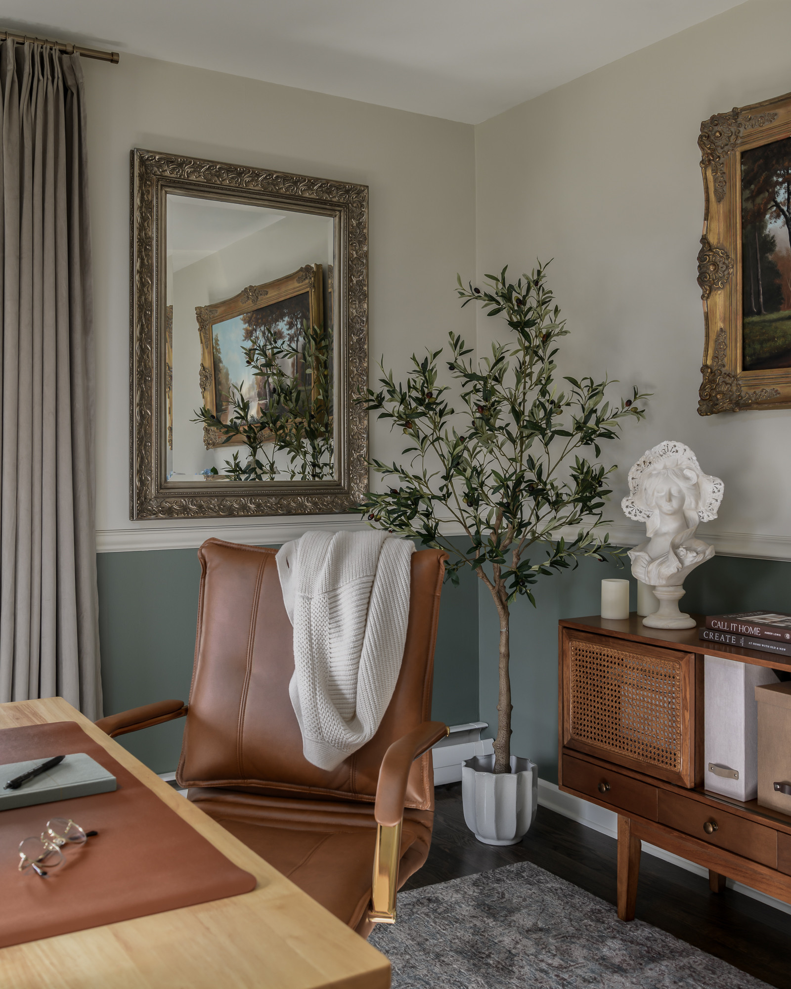 Home office with sage green walls and a leather swivel chair in a colonial home tour