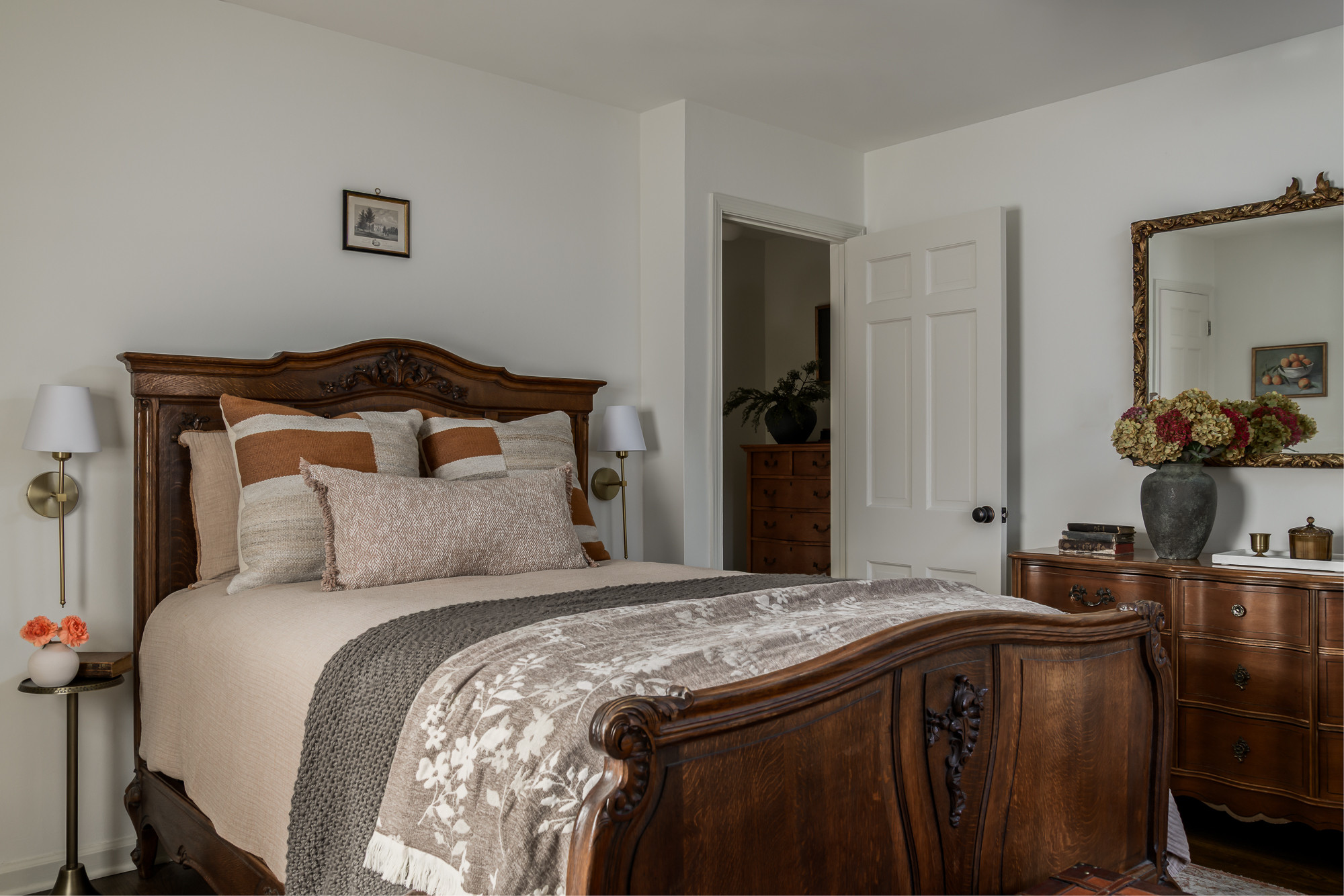 Primary bedroom with a carved antique wood bed in a colonial home tour