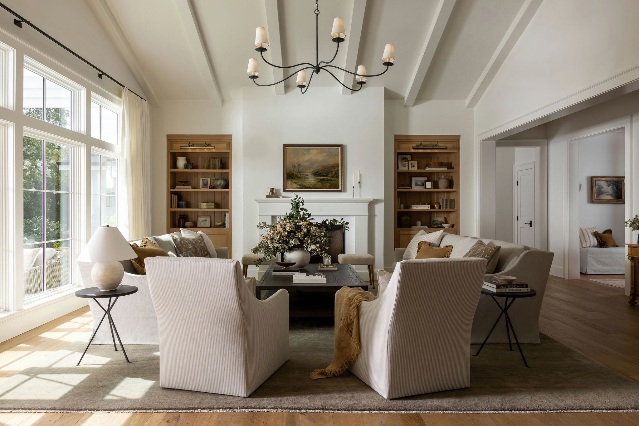 Living room with white fireplace and oak built-ins in a traditional home tour