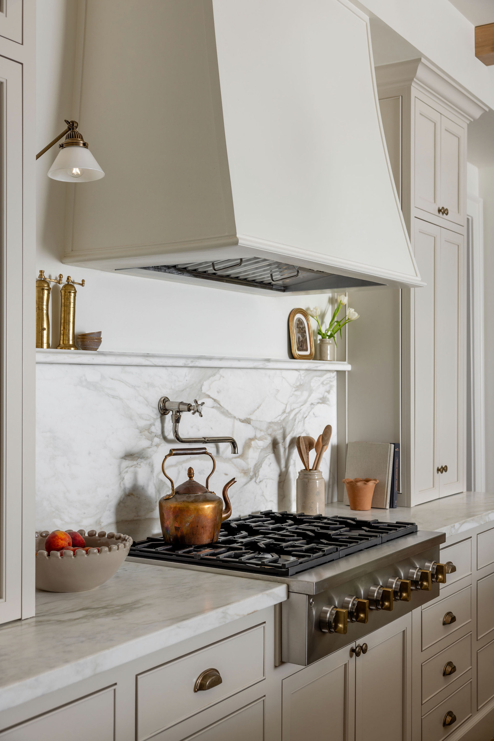 Kitchen with dark wood island and oak ceiling beams in a traditional home tour