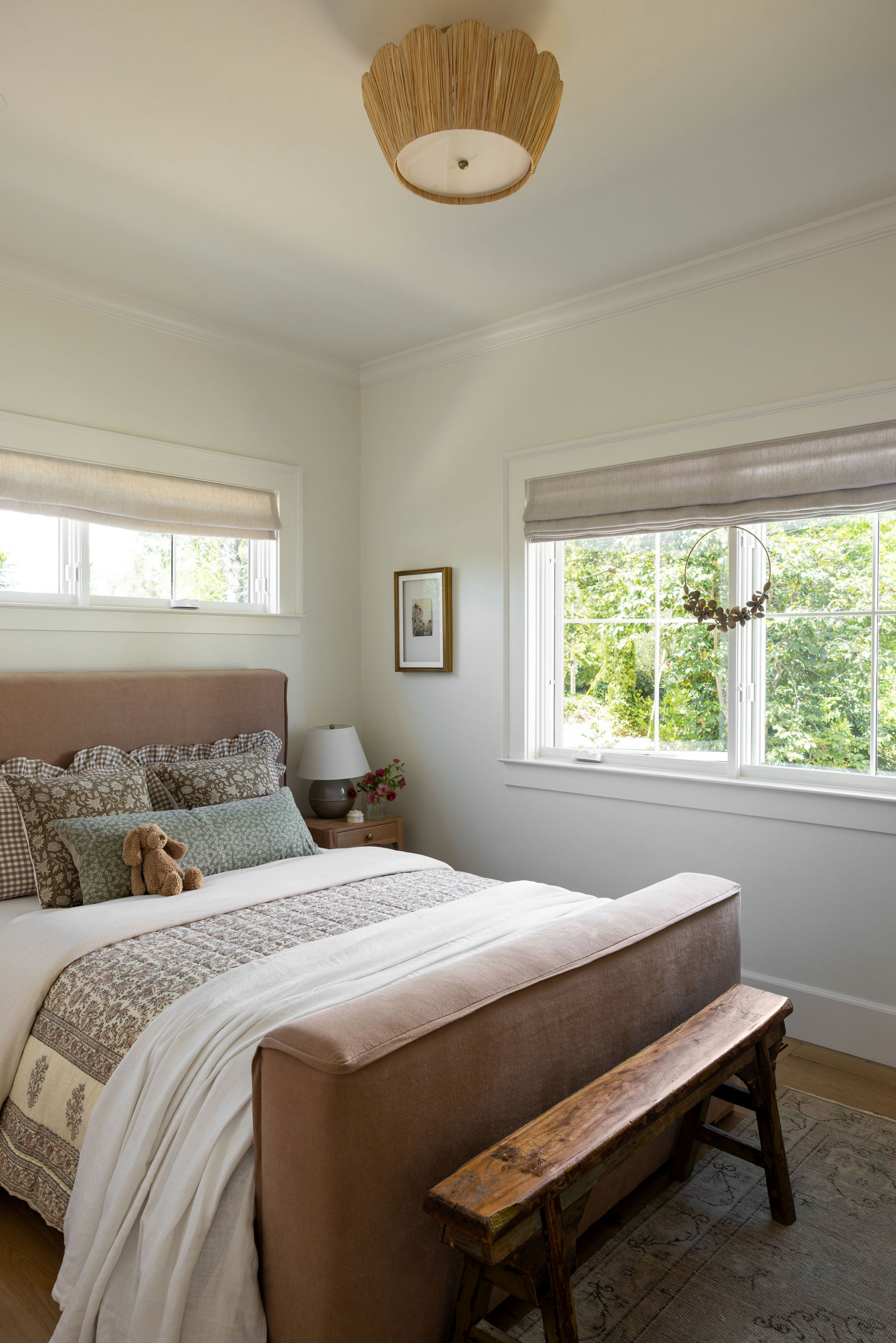 Child's bedroom with dusty rose headboard and mixed brown patterns in a traditional home tour