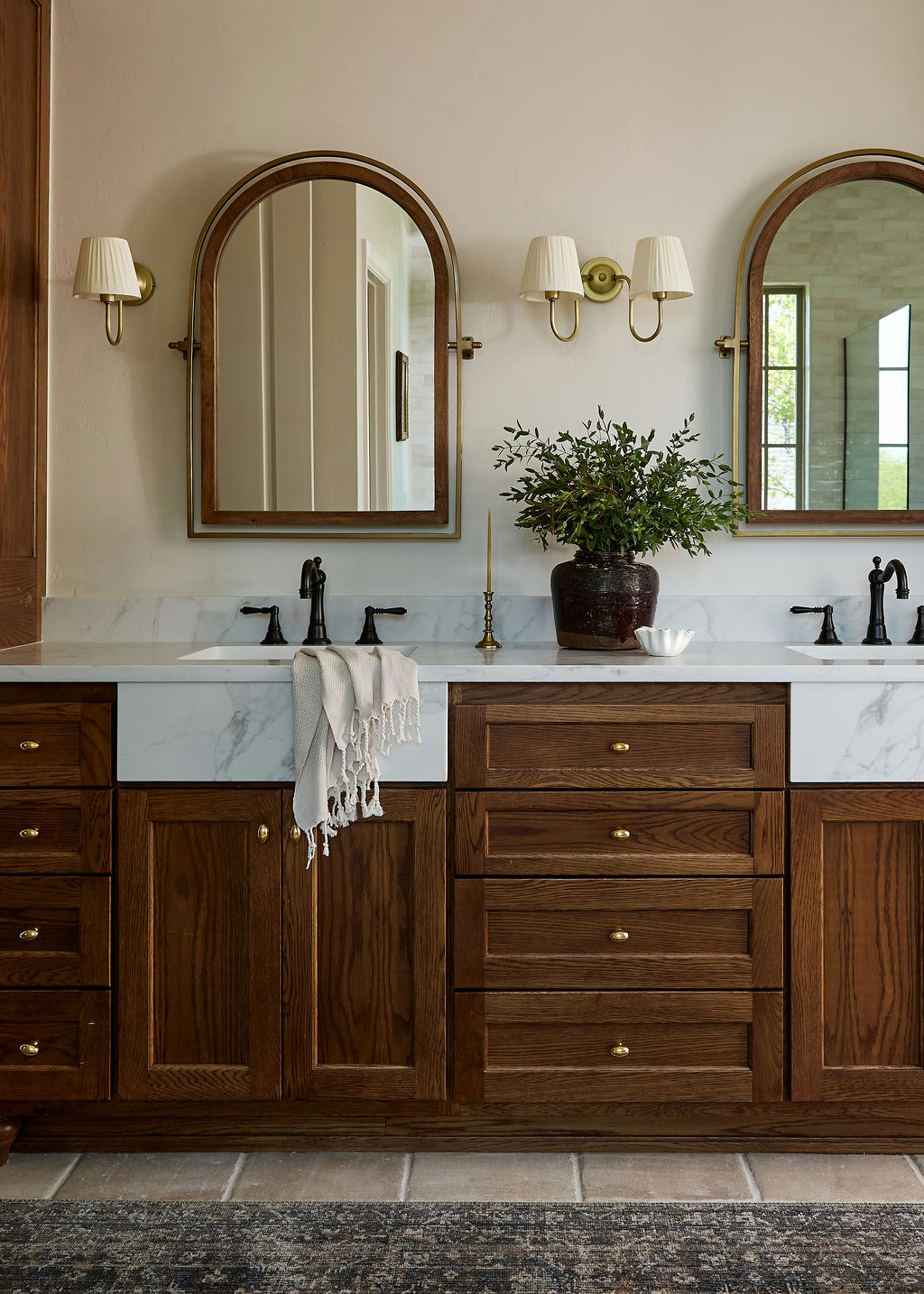 Mountain home tour primary bathroom with a freestanding tub under grid windows and beige glazed tile.
