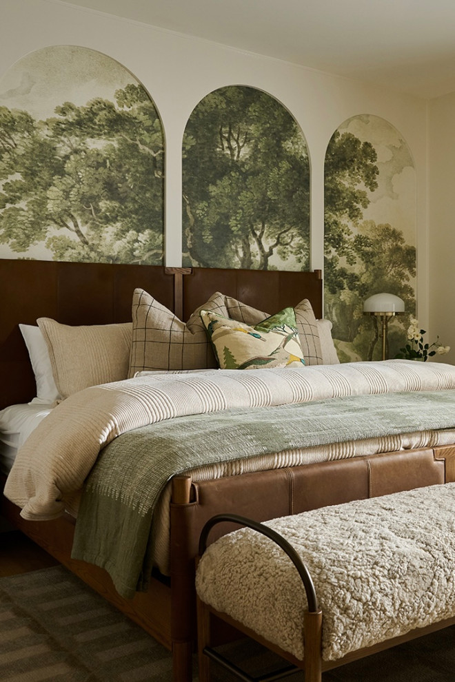 Bedroom with an arched landscape mural and leather bed in a Mediterranean home tour
