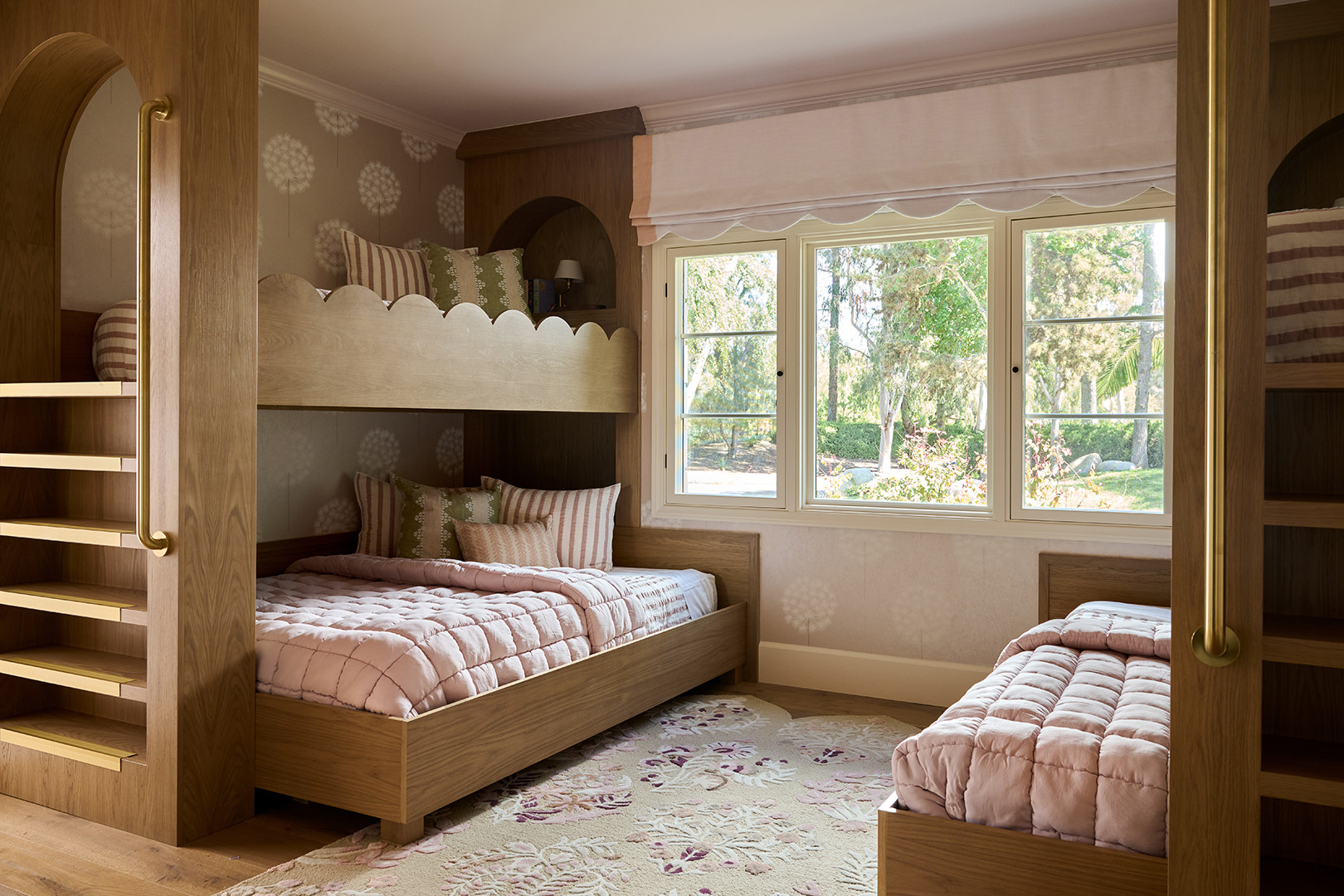 Kids' bunk room with scalloped oak bunks and arched reading nooks in a Mediterranean home tour